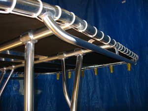 Custom extruded clamp assembly for adjustable Super Trampoline T-Top legs