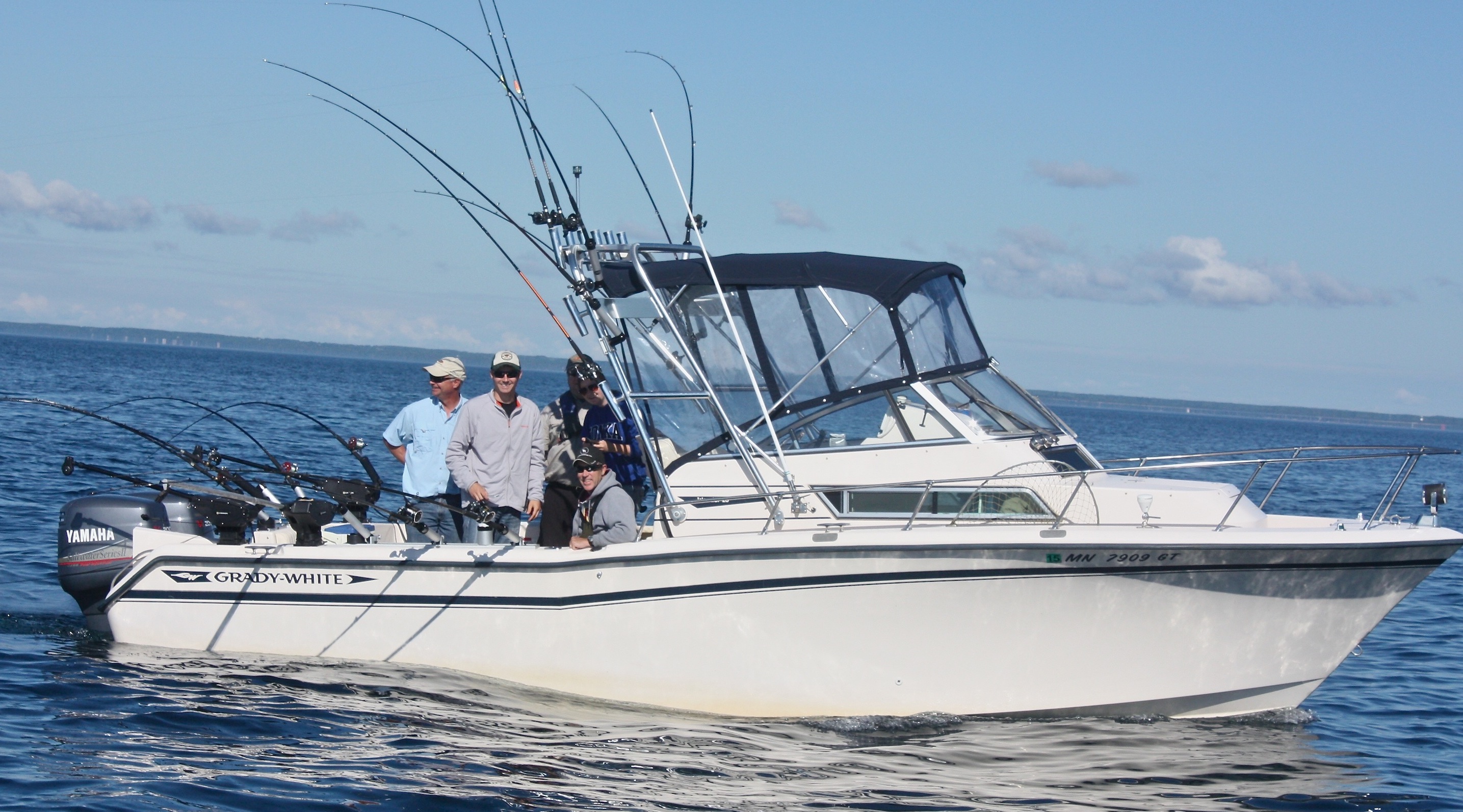Offshore boat with multiple fishing rods carried above the cockpit