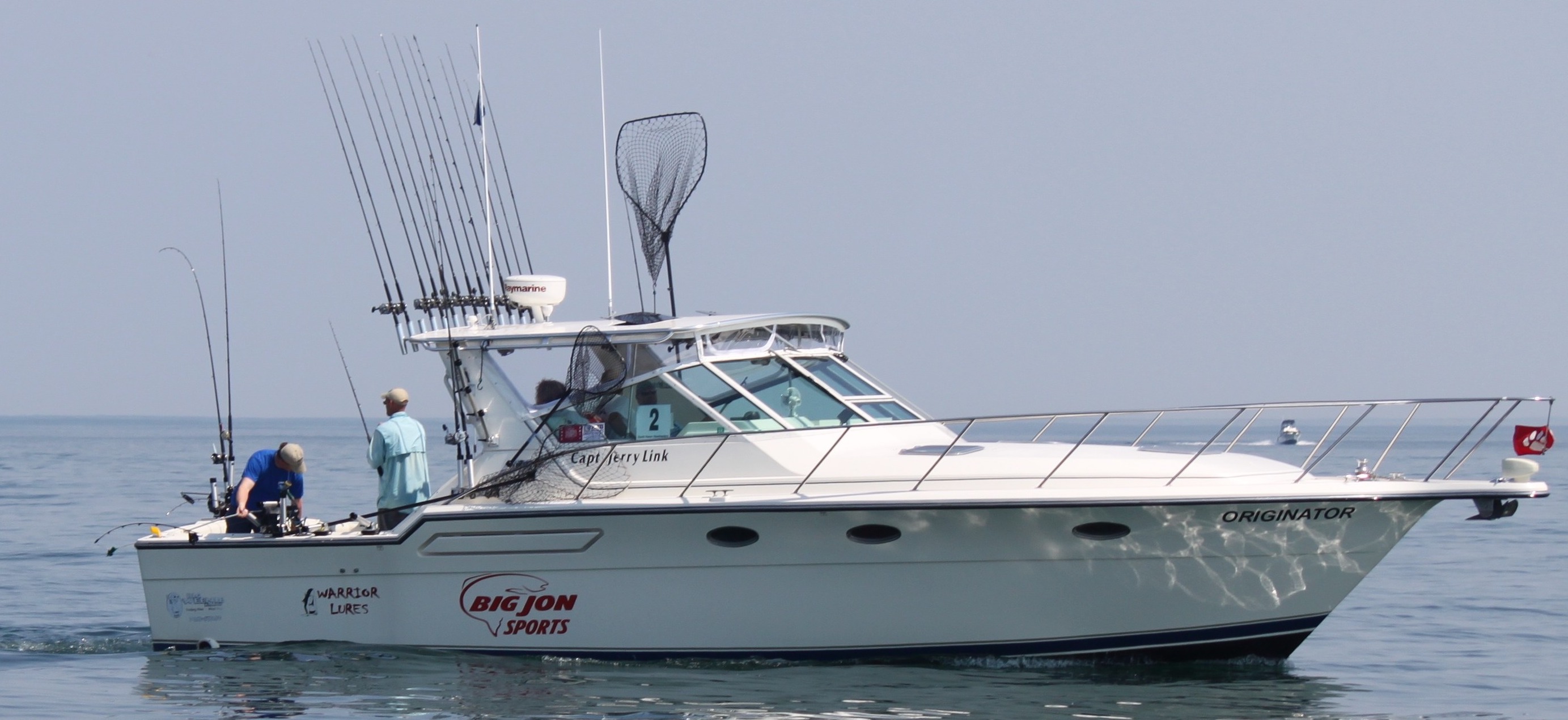 Fishing boat with a net and a dense roof-mounted rod array